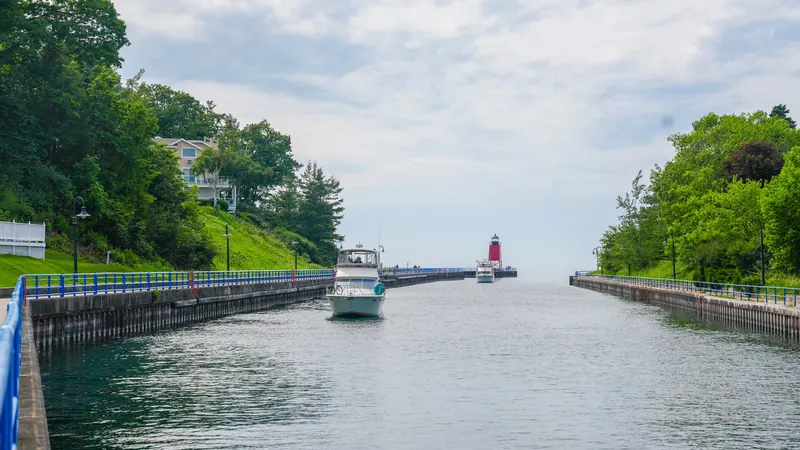Boats moving along the channel toward the red pierhead lighthouse