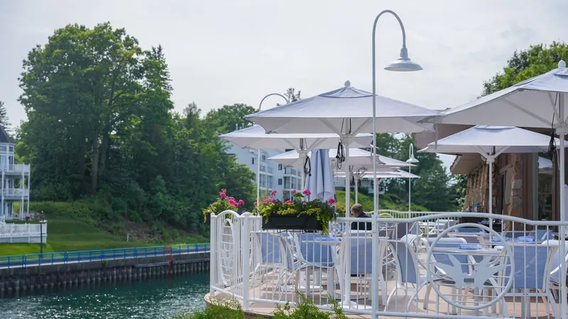 Deck chairs and umbrellas facing the water